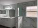 Modern bathroom featuring a glass-enclosed shower and double sink vanity at 14954 Lady Victoria Blvd, Orlando, FL 32826