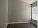 Bright bedroom featuring a large window with blinds and light gray walls at 14954 Lady Victoria Blvd, Orlando, FL 32826