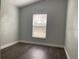 Bright bedroom featuring a large window with blinds and light gray walls at 14954 Lady Victoria Blvd, Orlando, FL 32826