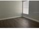 Bright bedroom featuring a large window with blinds and light gray walls at 14954 Lady Victoria Blvd, Orlando, FL 32826