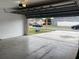 Open garage with automatic door, concrete floor, and view to the driveway at 14954 Lady Victoria Blvd, Orlando, FL 32826