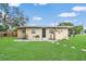 Home's backyard with lawn, patio, and fence, offering outdoor living and privacy at 1622 Dolphin Dr, St Cloud, FL 34771