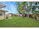 Expansive backyard featuring lush green lawn, play structure, shed, and privacy fence at 1622 Dolphin Dr, St Cloud, FL 34771