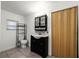 Bathroom featuring a black vanity with a vessel sink, a toilet, tiled floor, and a folding door at 1622 Dolphin Dr, St Cloud, FL 34771