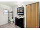 Well-lit bathroom with a sink vanity, storage rack, and a window for natural light at 1622 Dolphin Dr, St Cloud, FL 34771