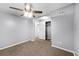 Spacious bedroom with a ceiling fan, carpet flooring, closet, and a view of another room at 1622 Dolphin Dr, St Cloud, FL 34771