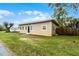 A charming exterior view showcasing the well-maintained lawn, fenced yard and neutral color scheme of the house at 1622 Dolphin Dr, St Cloud, FL 34771