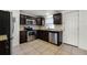 Well-lit kitchen featuring stainless steel appliances, granite countertops, and tile flooring at 1622 Dolphin Dr, St Cloud, FL 34771
