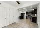 Open view from the tiled floor of the kitchen, with stainless appliances and brown cabinetry at 1622 Dolphin Dr, St Cloud, FL 34771