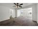 Open-concept living room and entryway featuring large windows and neutral color carpet floors at 1622 Dolphin Dr, St Cloud, FL 34771