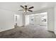 Open living room featuring carpet, natural light, and seamless access to other living spaces at 1622 Dolphin Dr, St Cloud, FL 34771