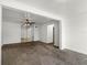 Spacious living room featuring neutral carpet, white trim and a view of the tile floor in the adjacent room at 1622 Dolphin Dr, St Cloud, FL 34771