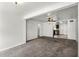 Living room area showcasing carpet, neutral paint, and seamless access to the adjacent kitchen at 1622 Dolphin Dr, St Cloud, FL 34771