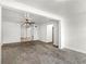 Open living area with plush carpeting and neutral paint, with a view to the kitchen at 1622 Dolphin Dr, St Cloud, FL 34771