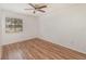 Bedroom featuring wood floors, a ceiling fan, and a window with blinds at 184 Dublin Dr, Lake Mary, FL 32746