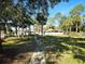 Scenic view of a community park with lush greenery, walking path, playground, and a lake nearby at 184 Dublin Dr, Lake Mary, FL 32746