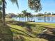 Picturesque lake view with palm trees and a small dock on a sunny day, enhancing the property's appeal at 184 Dublin Dr, Lake Mary, FL 32746