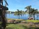 Picturesque lake view highlighting palm trees, a dock, and the tranquil water, creating a serene and inviting outdoor setting at 184 Dublin Dr, Lake Mary, FL 32746