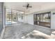 Enclosed lanai with ceiling fan, screened windows and tile flooring connects the interior to the pool and lake at 184 Dublin Dr, Lake Mary, FL 32746