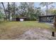 Wide shot of a large backyard with a movie screen and a screened-in porch at 200 Avenue C, Chuluota, FL 32766