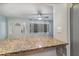 Breakfast bar with granite countertop overlooking the living room at 200 Avenue C, Chuluota, FL 32766