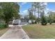 Inviting home with a long driveway, gray exterior, and mature trees at 200 Avenue C, Chuluota, FL 32766