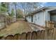 Side yard with a mix of grass and pine straw is fenced for privacy at 200 Avenue C, Chuluota, FL 32766