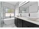 Stylish bathroom featuring dual sinks, a soaking tub, and contemporary marble tile at 2073 Home Again Rd, Apopka, FL 32712