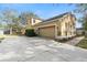 Charming two-story home featuring an attached garage and manicured landscaping at 2073 Home Again Rd, Apopka, FL 32712