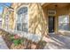 Inviting front porch featuring a brick pathway, black front door, and well-maintained landscaping at 2073 Home Again Rd, Apopka, FL 32712