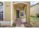 Inviting covered front porch with a black front door and manicured landscaping around the entrance at 2073 Home Again Rd, Apopka, FL 32712