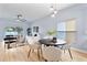 Bright living area featuring an adjacent dining area, ceiling fan, and hardwood flooring at 2073 Home Again Rd, Apopka, FL 32712