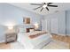 Bright main bedroom with hardwood floors, featuring a ceiling fan, and a neutral color palette for relaxation at 2073 Home Again Rd, Apopka, FL 32712