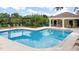 Resort-style community pool with lounge chairs and a covered pergola for poolside relaxation at 2073 Home Again Rd, Apopka, FL 32712