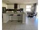 Modern kitchen with granite island, stainless steel appliances, and adjacent dining area at 2475 Verde View Dr, Apopka, FL 32703