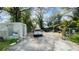 View of the cluttered front yard with multiple vehicles parked on the property at 2516 Cannon St, Lakeland, FL 33815