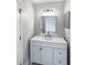 Clean bathroom with a modern vanity, a framed mirror, and updated lighting fixtures at 2720 Settlers Trl, St Cloud, FL 34772