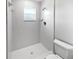 Bright bathroom with shower, toilet, and window at 2720 Settlers Trl, St Cloud, FL 34772