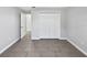 Bedroom with tile floors, gray walls, bi-fold closet doors and a view into another room at 2720 Settlers Trl, St Cloud, FL 34772