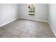 Simple bedroom with tile floors, a window view, and fresh paint at 2720 Settlers Trl, St Cloud, FL 34772