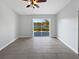 Bright bedroom with neutral walls, ceiling fan, tile floors and sliding glass doors to a lake view at 2720 Settlers Trl, St Cloud, FL 34772