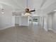 Bright living room boasting vaulted ceilings, fan, tile floors and backyard views at 2720 Settlers Trl, St Cloud, FL 34772