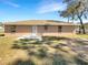 Rear exterior showcasing the backyard with a patio area and neutral-colored siding at 30 Hemlock Trce, Ocala, FL 34472