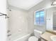 Clean bathroom with a tub, shower, toilet, vanity, and a bright window at 30 Hemlock Trce, Ocala, FL 34472