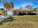 Charming single-story home with a well-maintained lawn, attached garage, and inviting curb appeal at 30 Hemlock Trce, Ocala, FL 34472