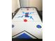 The game room features a sleek air hockey table ready for friendly competition and entertainment at 301 Sandy Ridge Dr, Davenport, FL 33896