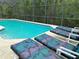 Inviting screened pool area with clear blue water and comfortable chaise lounge chairs for relaxation at 301 Sandy Ridge Dr, Davenport, FL 33896