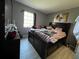 Cozy bedroom featuring neutral colored walls, wood-look floors and a window for natural light at 307 N Oak Ave, Fort Meade, FL 33841