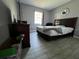 A tidy bedroom featuring neutral colored walls, wood-look floors and a window for natural light at 307 N Oak Ave, Fort Meade, FL 33841