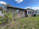 The side exterior of a brick home, showing a small yard at 307 N Oak Ave, Fort Meade, FL 33841